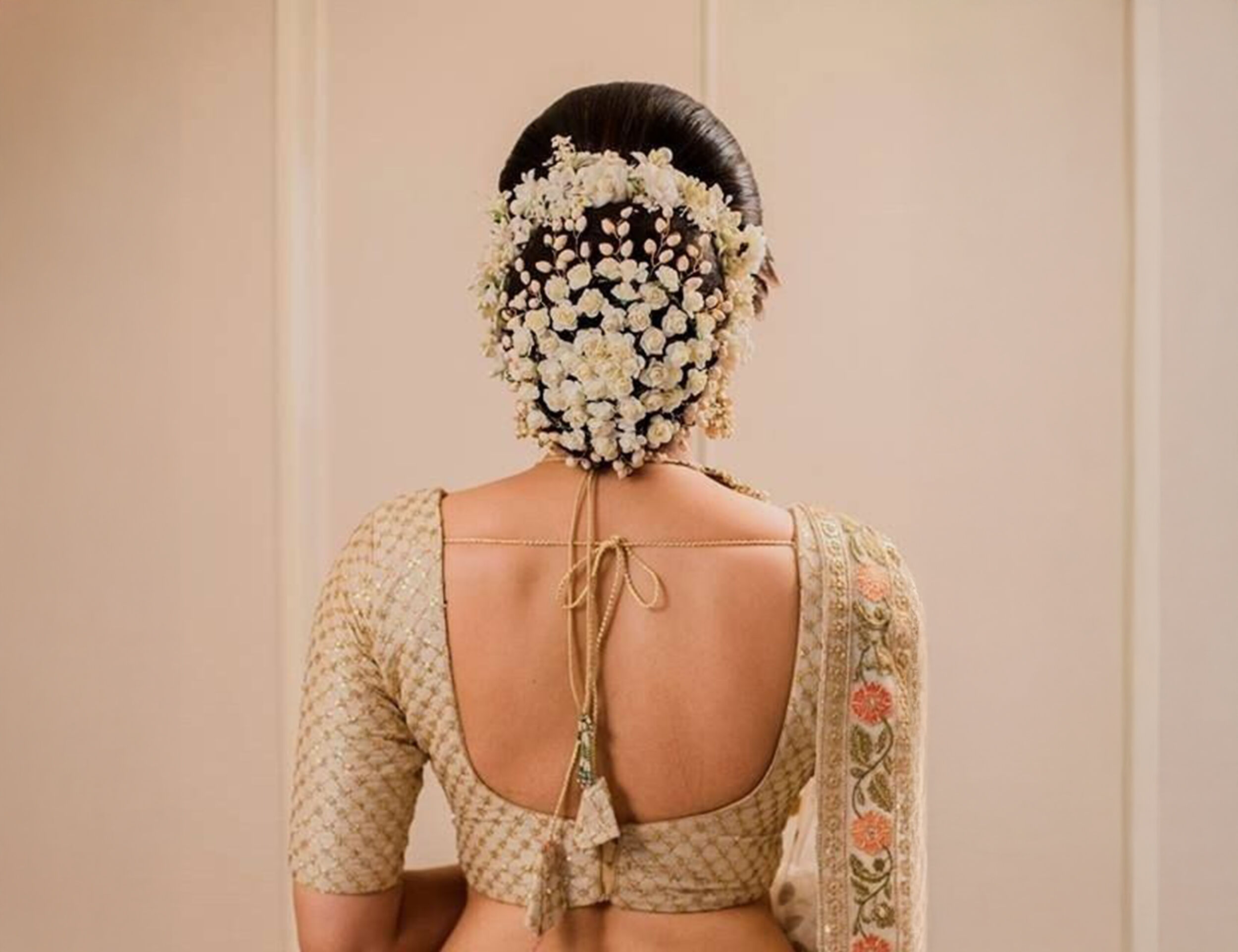 Bride flaunting the classic gajra with bun hairstyle